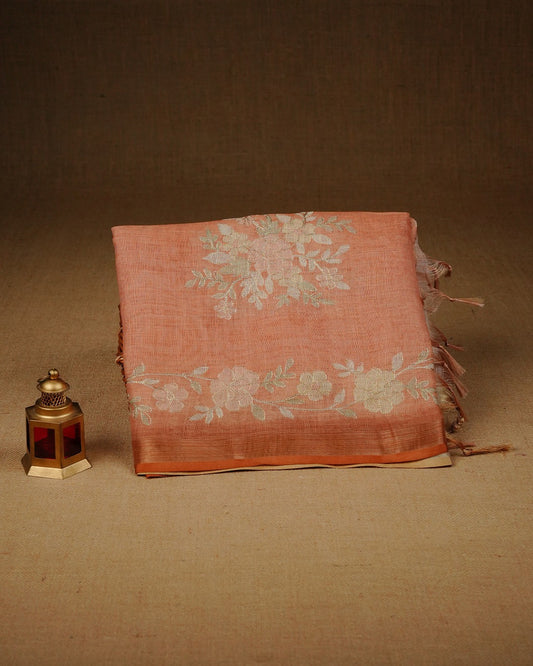 Burnt orange colour linen tissue saree featuring Floral design with Aari work & contrast simple border, comes with matching blouse piece.