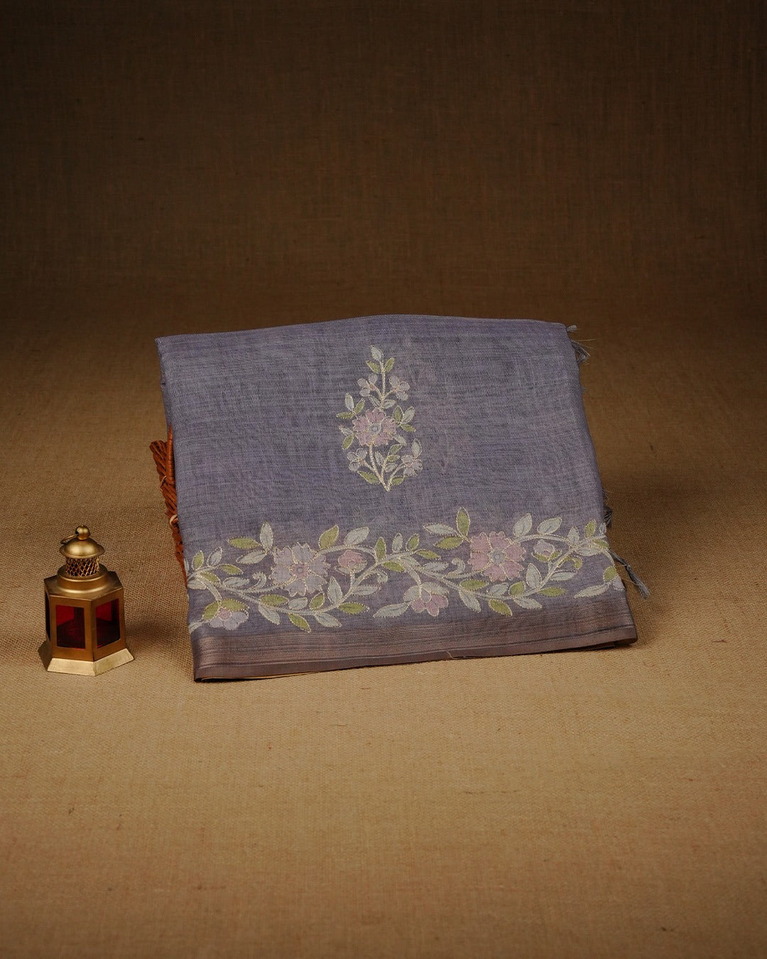 Lavender colour linen tissue saree featuring Floral design with Aari work & contrast simple border, comes with matching blouse piece.