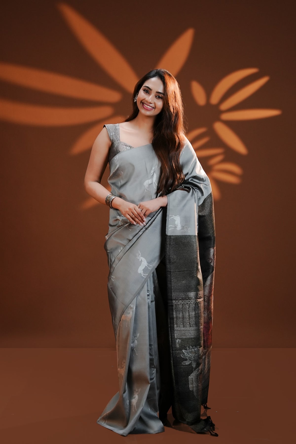 Silver Grey Traditional Kancheepuram Saree featuring silver zari deer motifs on the body, with a Raja Ravi Varma-inspired Hamsa Damayanti art printed pallu and silver zari deer motifs, paired with a matching blouse piece.