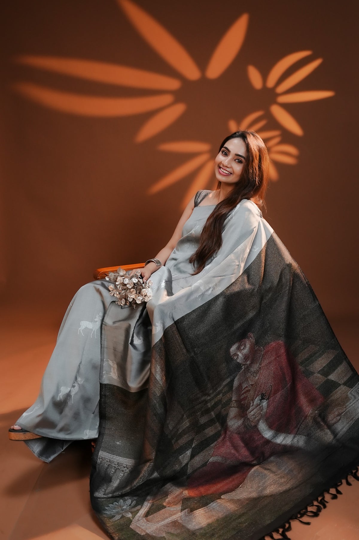 Silver Grey Traditional Kancheepuram Saree featuring silver zari deer motifs on the body, with a Raja Ravi Varma-inspired Hamsa Damayanti art printed pallu and silver zari deer motifs, paired with a matching blouse piece.