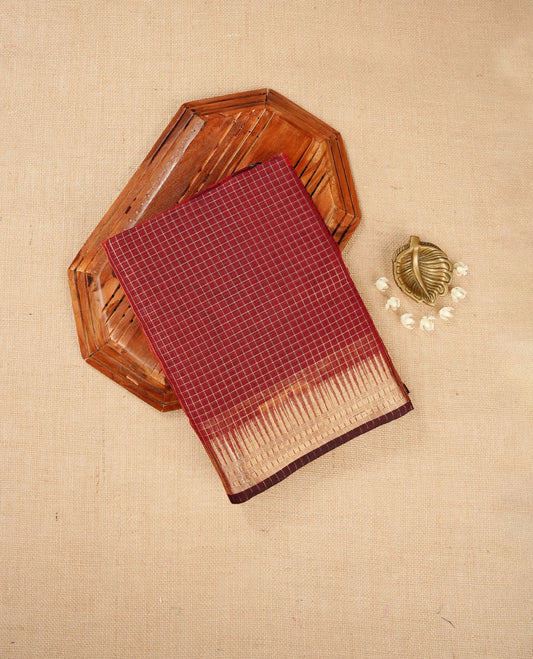 Dark maroon colour Maheshwari cotton saree, gold zari small checks on body, complement self colour gold zari temple design border comes with matching blouse.