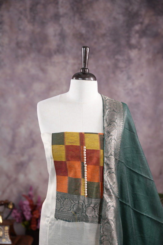 Green colour tissue Madras check salwar material featuring a plain body with a classic Kasavu border, paired with a Chanderi dupatta adorned with a matching Kasavu border and a Shantoon fabric bottom.