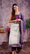 Violet  colour tissue Madras check salwar material featuring a plain body with a classic Kasavu border, paired with a Chanderi dupatta adorned with a matching Kasavu border and a Shantoon fabric bottom.