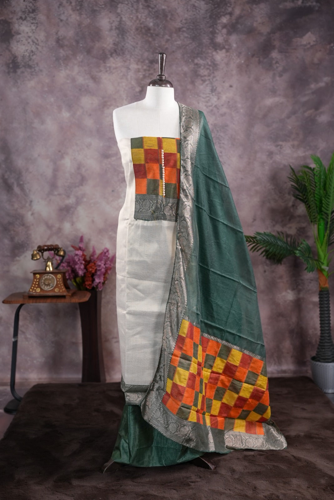 Green colour tissue Madras check salwar material featuring a plain body with a classic Kasavu border, paired with a Chanderi dupatta adorned with a matching Kasavu border and a Shantoon fabric bottom.