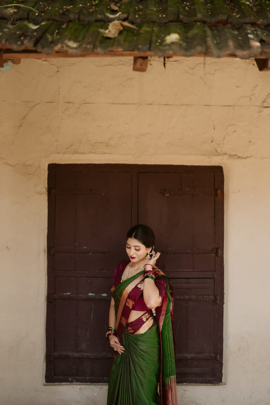 Bottle green colour silk cotton saree featuring  copper zari Check motifs on body ,contrast maroon with copper zari motifs on border & pallu, comes with matching blouse piece