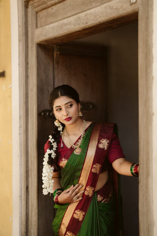 Bottle green colour silk cotton saree featuring  copper zari Check motifs on body ,contrast maroon with copper zari motifs on border & pallu, comes with matching blouse piece