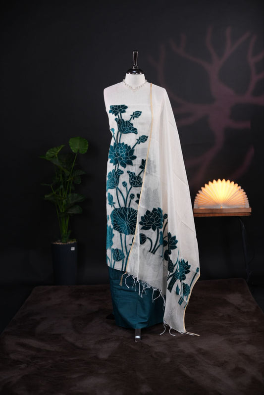 White net kota salwar material featuring Peacock Velvet applique work on body, paired with matching colour santoon bottom, elegant dupatta.