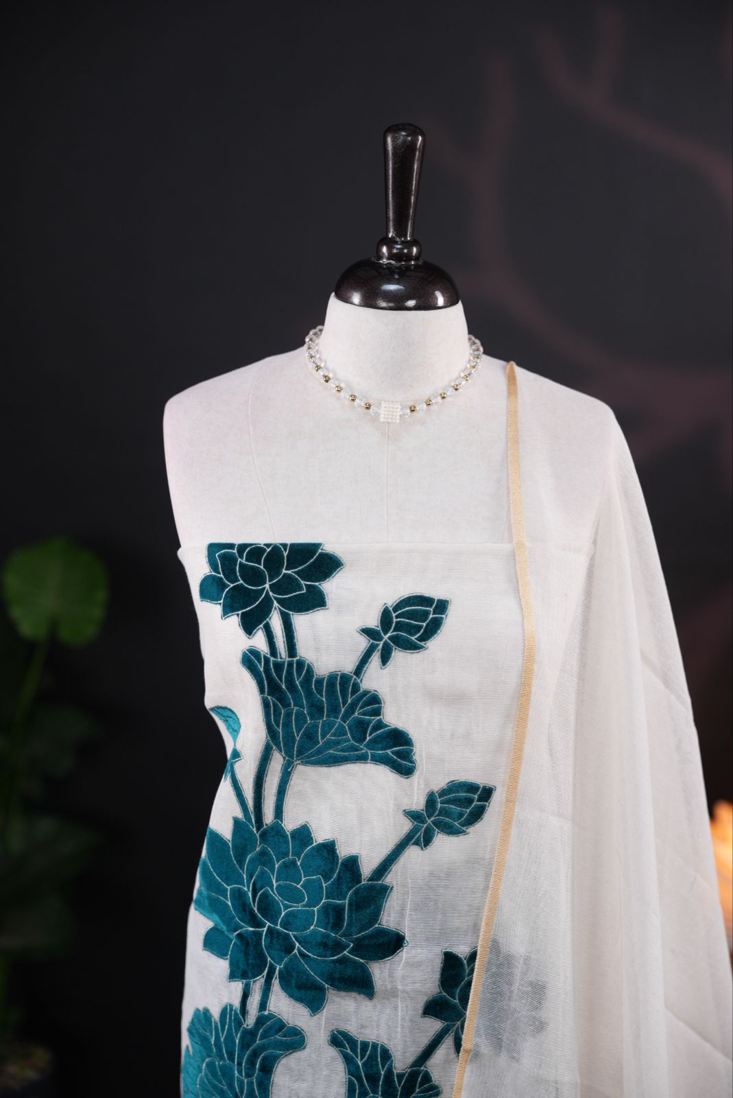 White net kota salwar material featuring Peacock Velvet applique work on body, paired with matching colour santoon bottom, elegant dupatta.