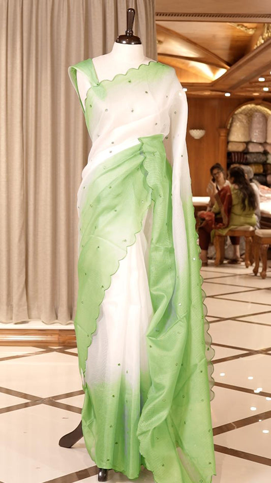 Green colour Doriya check cotton saree with soft sequins work on the body, elegant embroidery scallop border, and a simple pallu & Comes with a matching plain blouse piece.