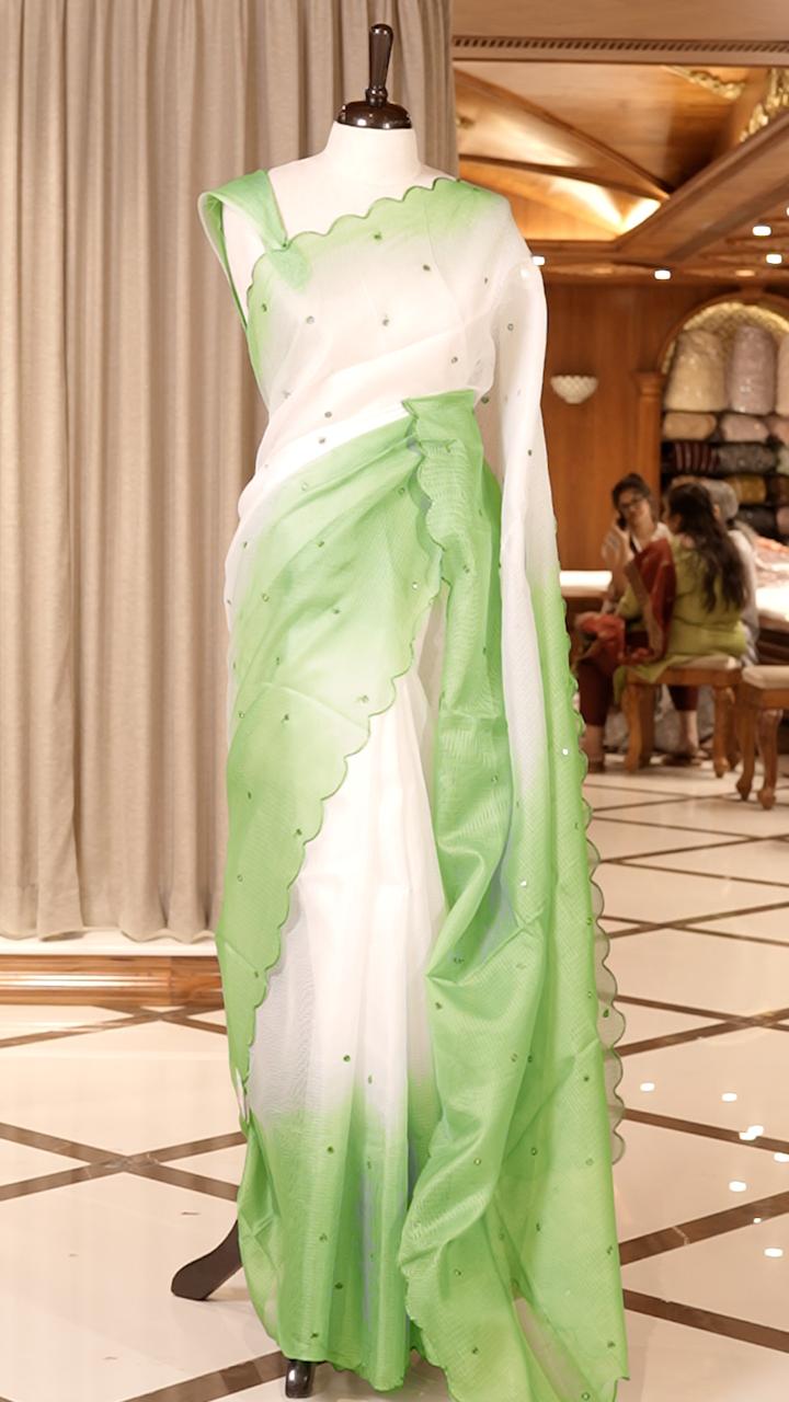 Green colour Doriya check cotton saree with soft sequins work on the body, elegant embroidery scallop border, and a simple pallu & Comes with a matching plain blouse piece.