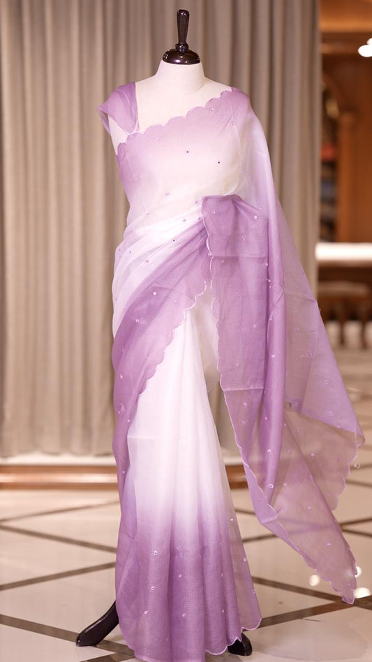 Lavender colour Doriya check cotton saree with soft sequins work on the body, elegant embroidery scallop border, and a simple pallu & Comes with a matching plain blouse piece.