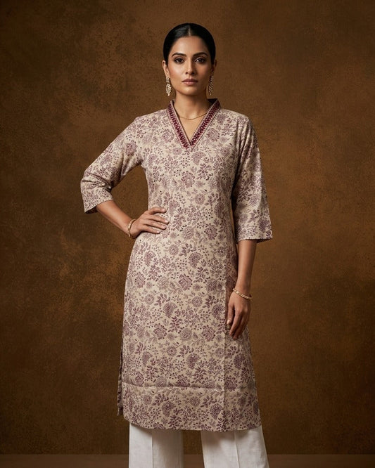 Cream colour kurti with styled with a thread pattern around neckline, print on body knee length design, and a sleeve .