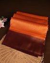 Rust orange colour softie silk saree featuring floral gold zari pattern across body, complemented by contrast chocolate brown with gold zari border, paired with matching blouse
