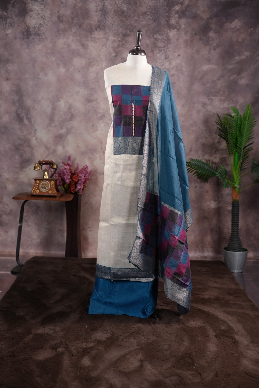 Peacock Blue colour tissue Madras check salwar material featuring a plain body with a classic Kasavu border, paired with a Chanderi dupatta adorned with a matching Kasavu border and a Shantoon fabric bottom.