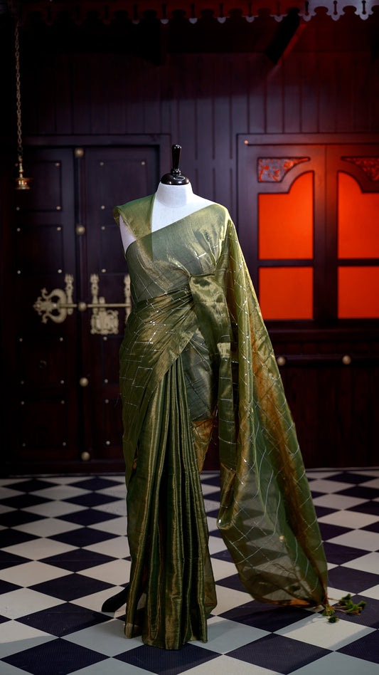 Parrot Green colour Semi Tissue Material saree with on all-over check design with silver sequin work on body, comes with a self blouse and a self pallu.