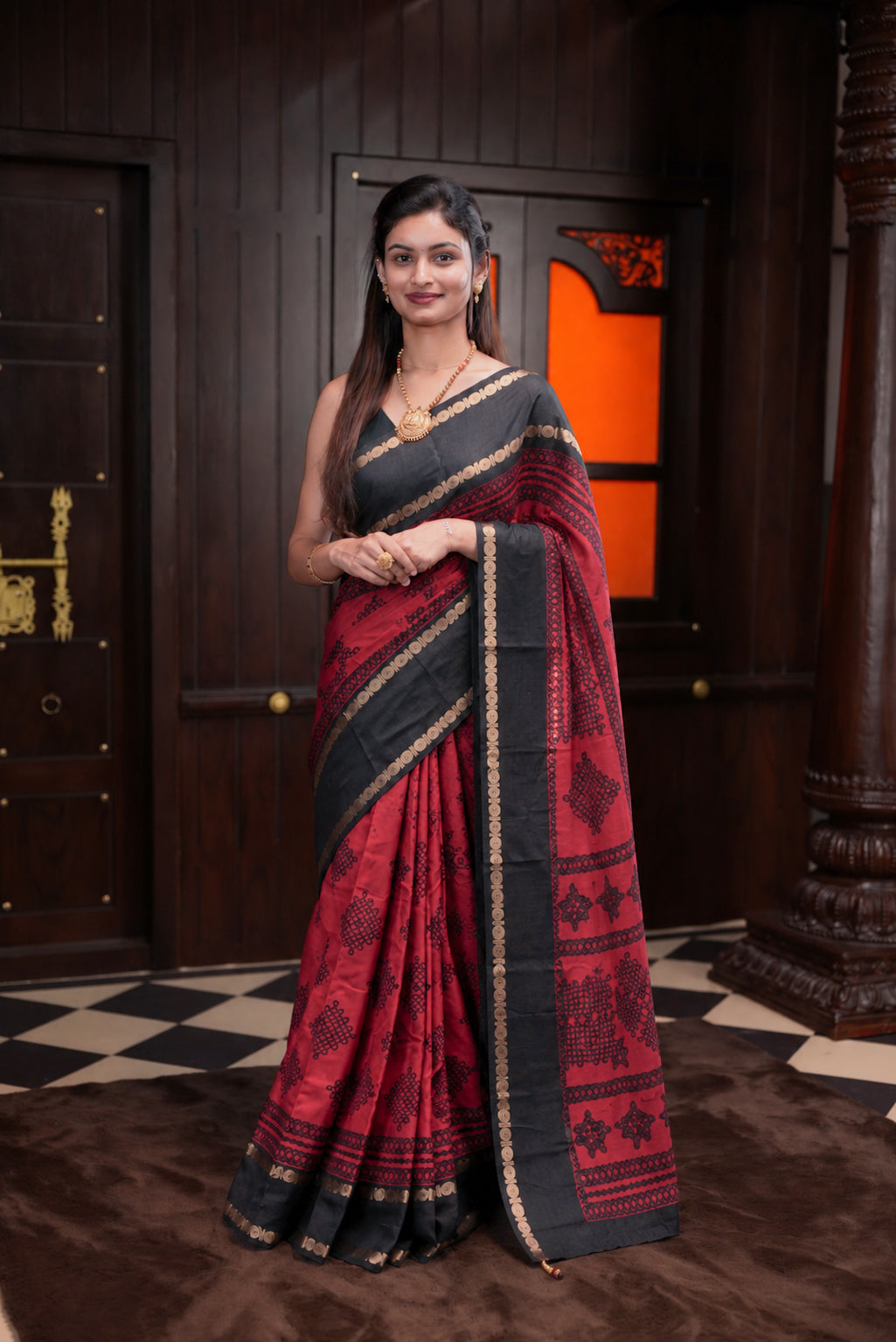 Black with Red Colour ManiPuri silk saree featuring Kolam Design body, contrast Double Peth Border, contrast Self print blouse.