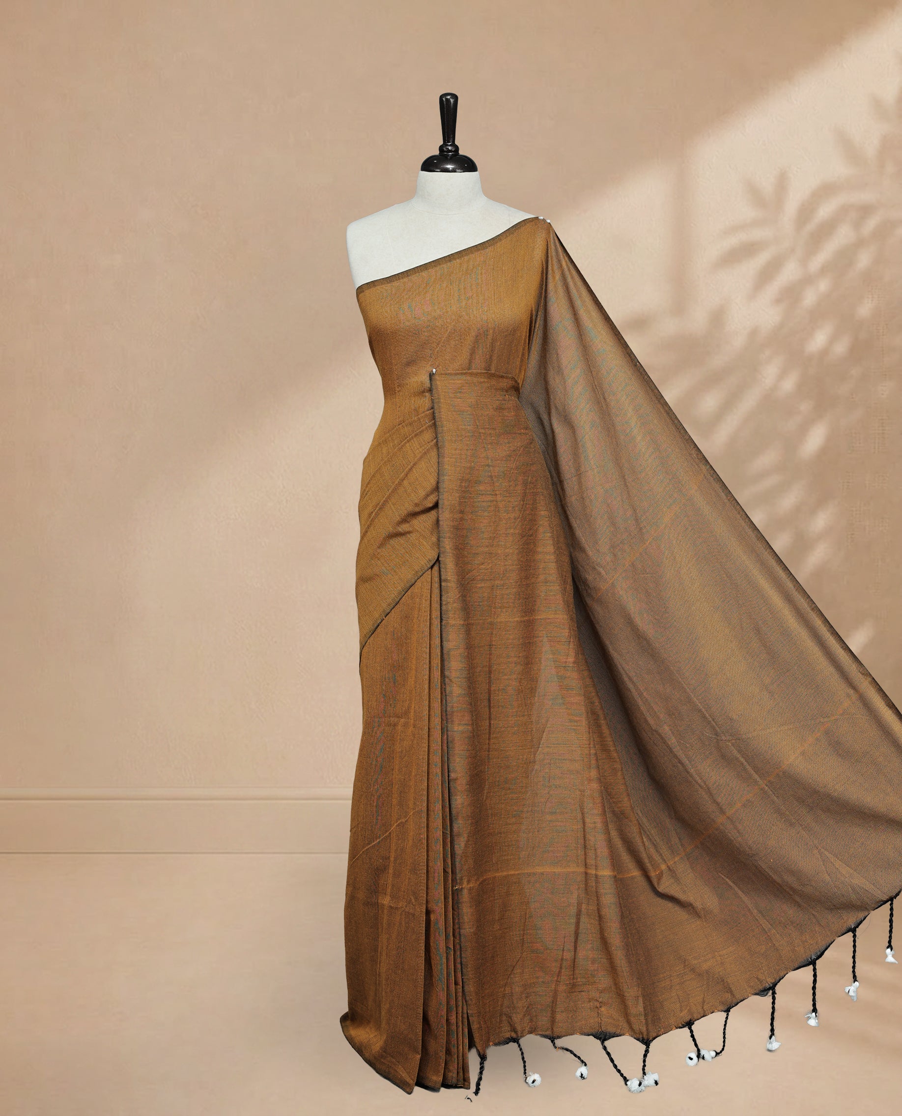 Mustard Colour Mul Cotton saree featuring Elegant plain body, Comes with no border, finished with stylish tassels.