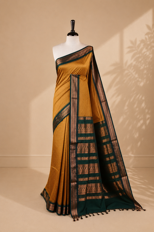 Mustard colour kalyani cotton saree featuring gold zari check pattern on body, complemented by green colour with Antique zari border, paired with matching blouse piece.