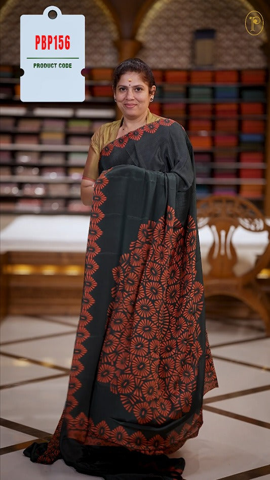 Black and red colour Turkey crepe saree with an bigcircle fancy print on the pallu, stylish printed border, and matching blouse.