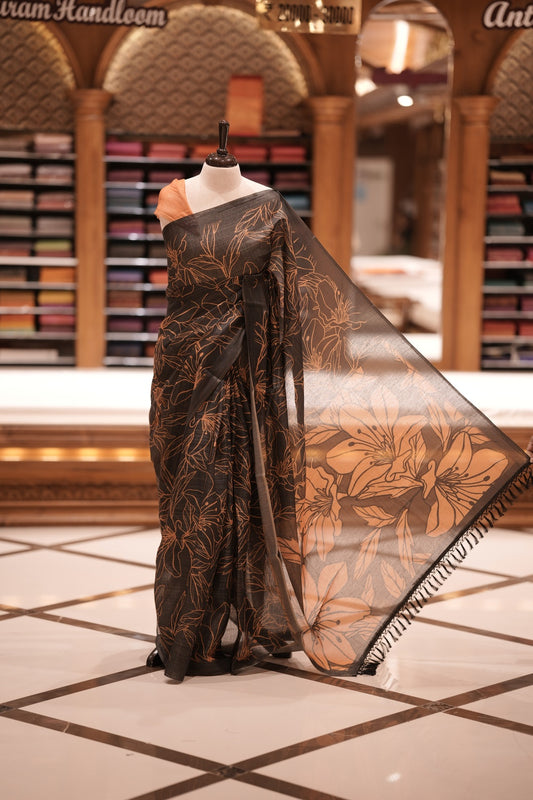 Black & Yellow colour Semi linen tissue saree featuring full digital floral prints across the body, The saree is highlighted with a contrast floral printed pallu and comes with a plain contrasting blouse piece.