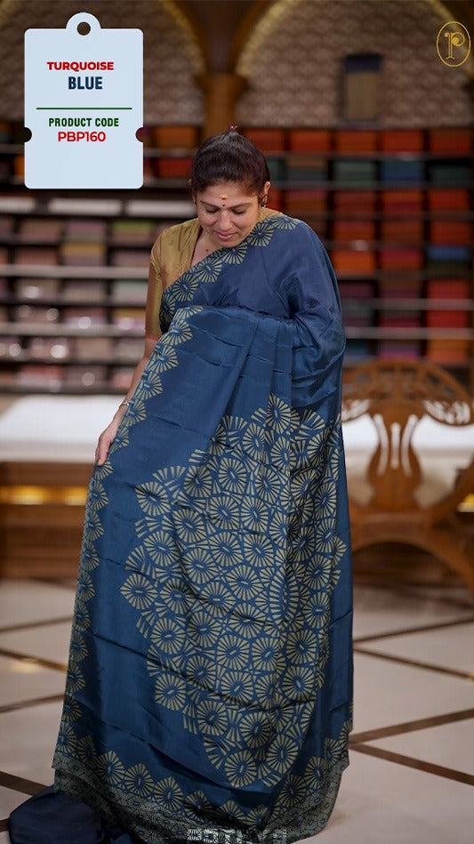 Turquoise blue and light green colour Turkey crepe saree with an bigcircle fancy print on the pallu, stylish printed border, and matching blouse.