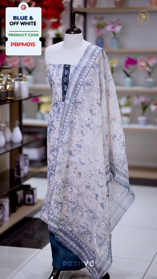 Off white colour jute cotton salwar material with blue leaf prints, featuring embroidery and mirror work on the neckline, paired with a printed dupatta and a contrast blue bottom for a graceful and elegant look.