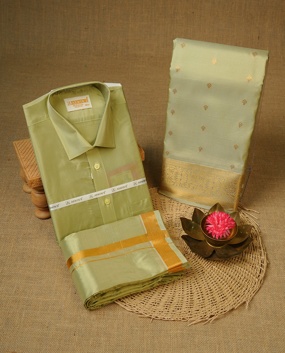 Firgreen colour shirt and dhoti with gold colour border, paired with matching colour silk saree featuring gold zari buttas and traditional border paired with matching blouse piece.