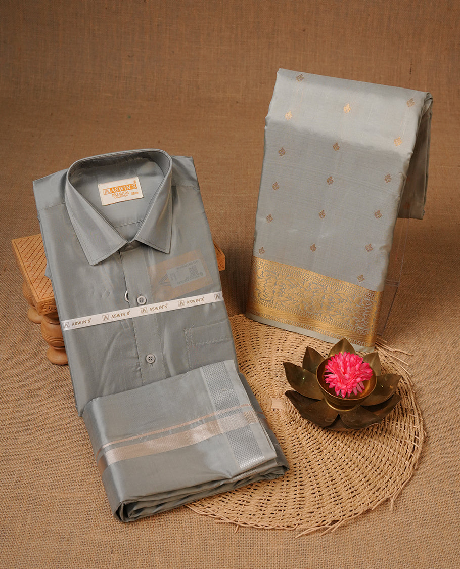 Grey colour shirt and dhoti with silver colour border, paired with matching colour silk saree featuring gold zari buttas and traditional border paired with matching blouse piece.