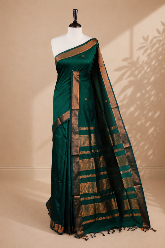 Green colour kalyani cotton saree featuring antique zari motifs on body, complemented by Self colour with Antique zari border, paired with matching blouse piece.