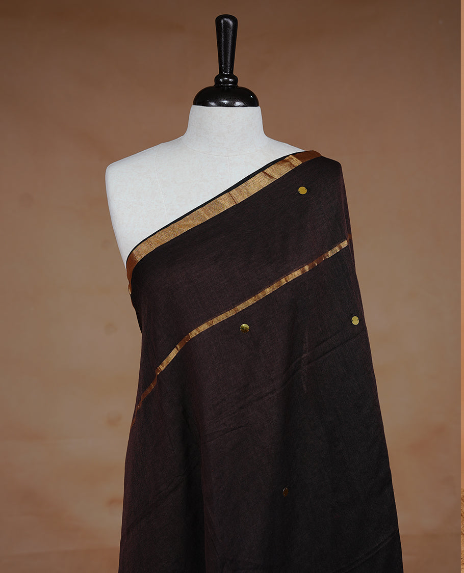 Brown colour Mul Cotton saree featuring a plain body with sequin detailing, highlighted by a small gold colour border, without blouse piece.