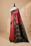 Pinkish peach colour kalyani cotton saree featuring gold zari check pattern on body, complemented by green colour with Antique zari border, paired with matching blouse piece.