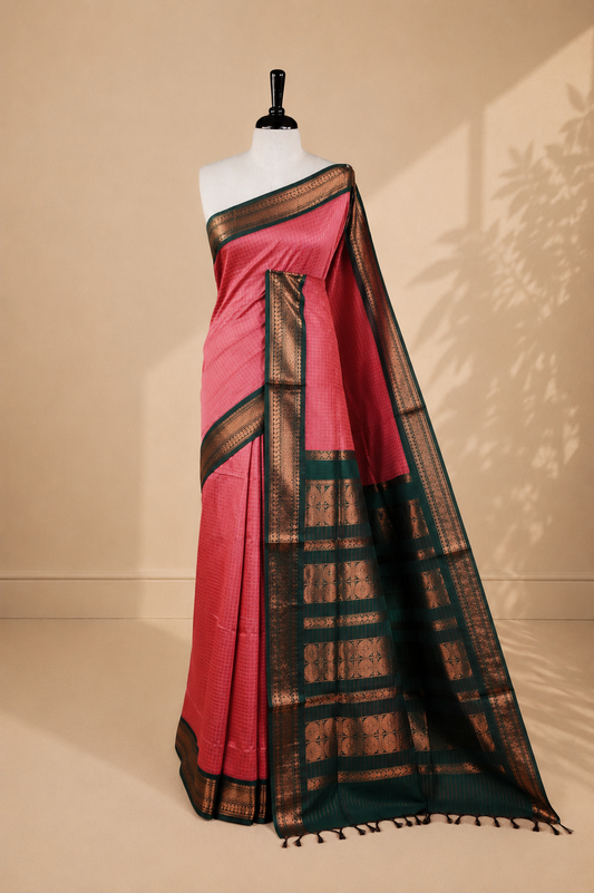 Pinkish peach colour kalyani cotton saree featuring gold zari check pattern on body, complemented by green colour with Antique zari border, paired with matching blouse piece.