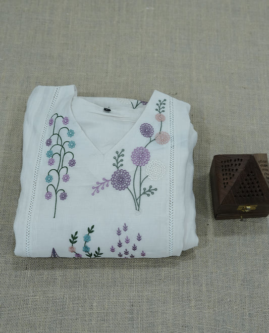 white colour salwar suit with subtle pastel floral embroidery. Simple, elegant, and ideal for casual outings or daytime events.
