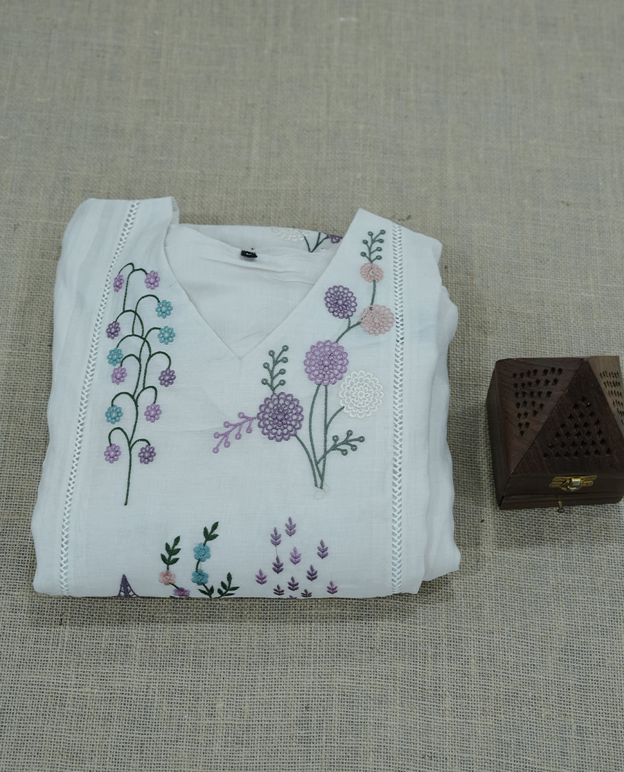 white colour salwar suit with subtle pastel floral embroidery. Simple, elegant, and ideal for casual outings or daytime events.