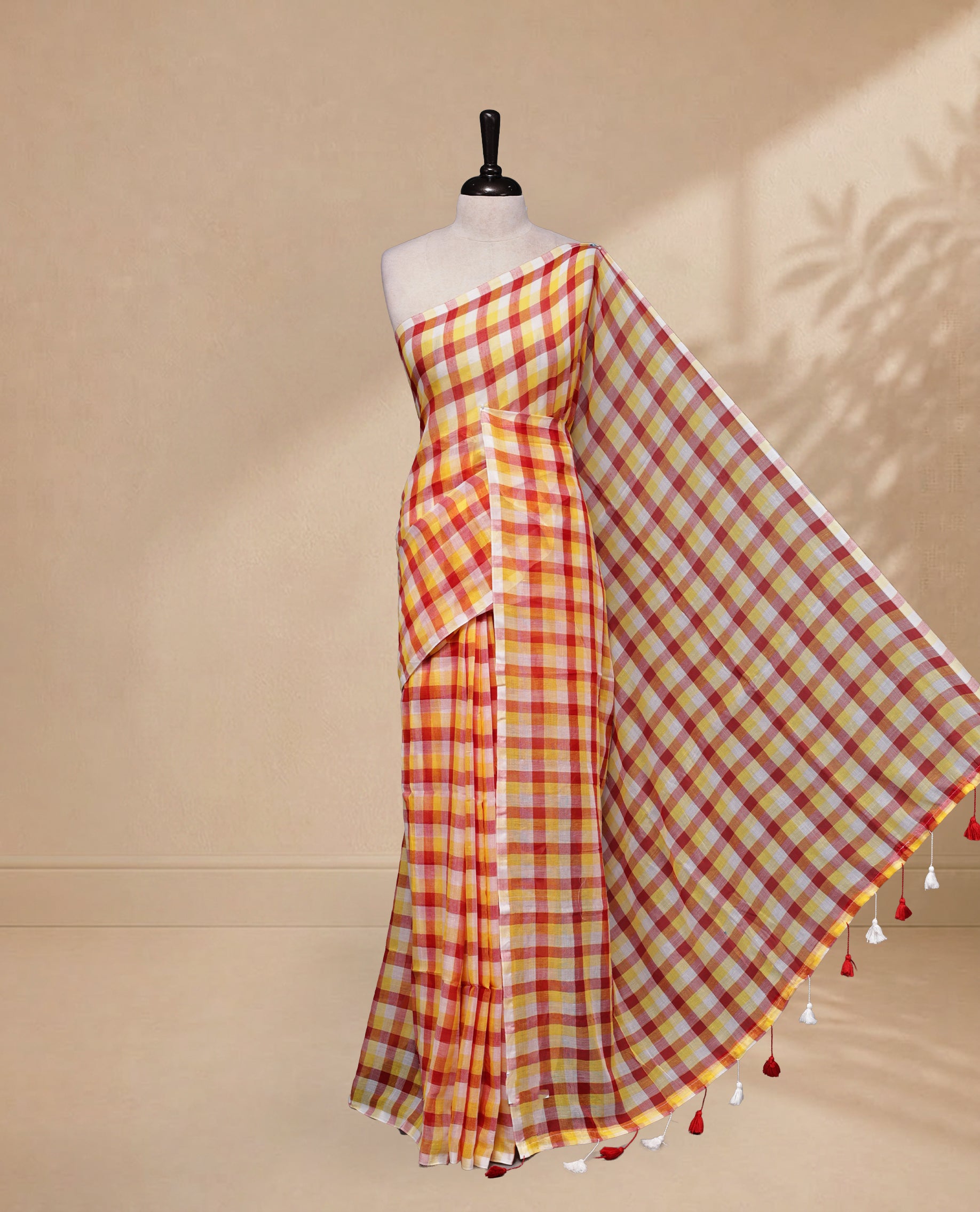 Yellow & Red colour Khadi Mul cotton saree featuring Check Pattern on body,Enhanced Minimalist Borderless Finish & elegant Tassels at pallu.