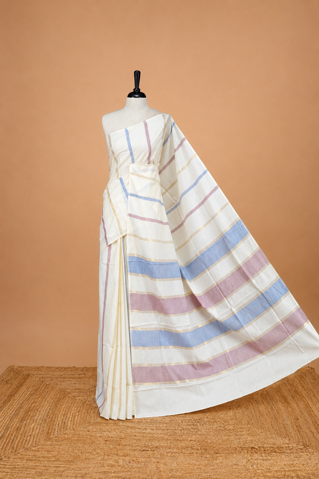 Cream Colour Cotton Kerala Saree Featuring  Blue & Light Purple Strips On The Body & Pallu, Paired With A Matching Blouse Piece.