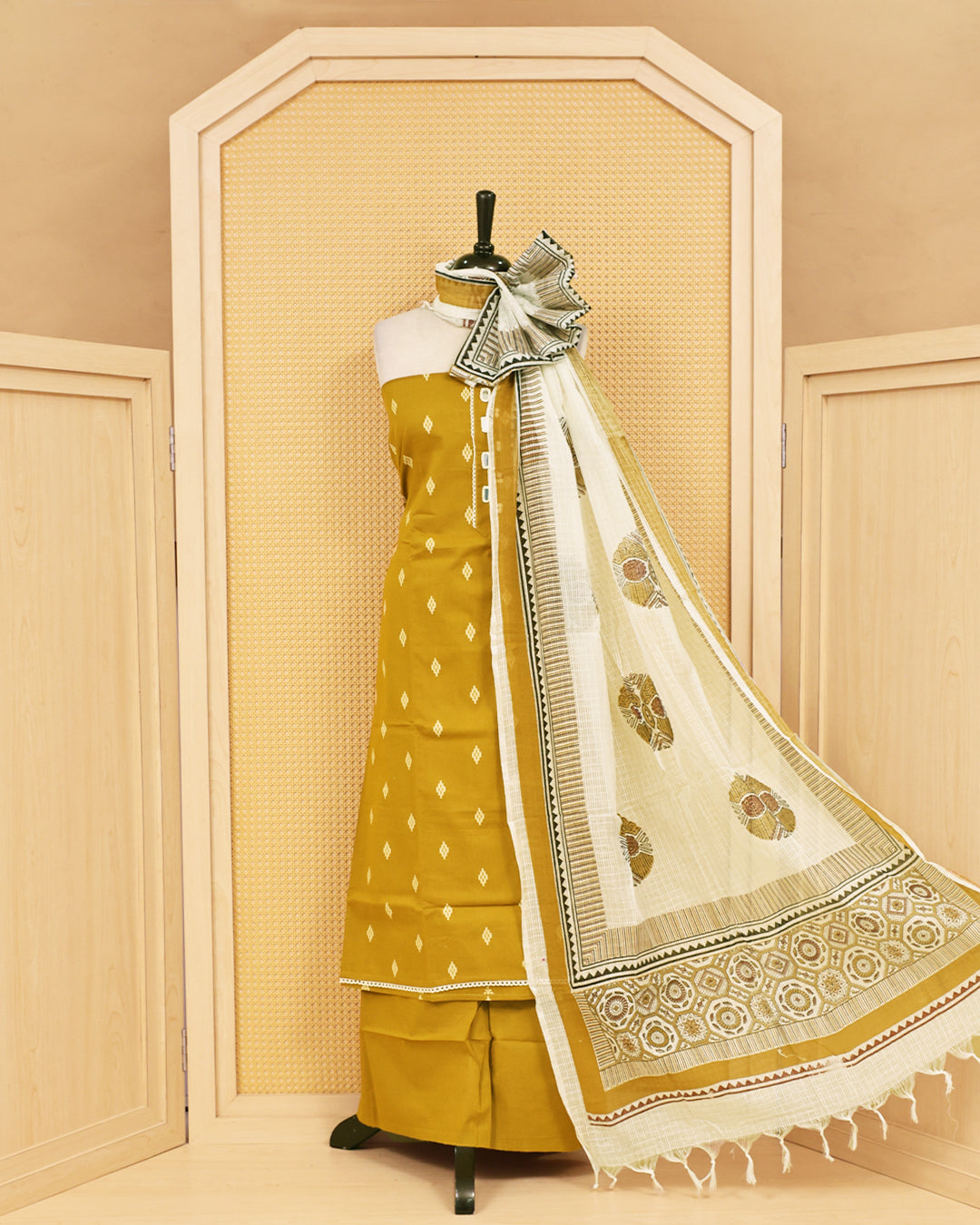 Mustard colour Cotton salwar material featuring Thread with mirror work on body, paired with matching bottom & dupatta.