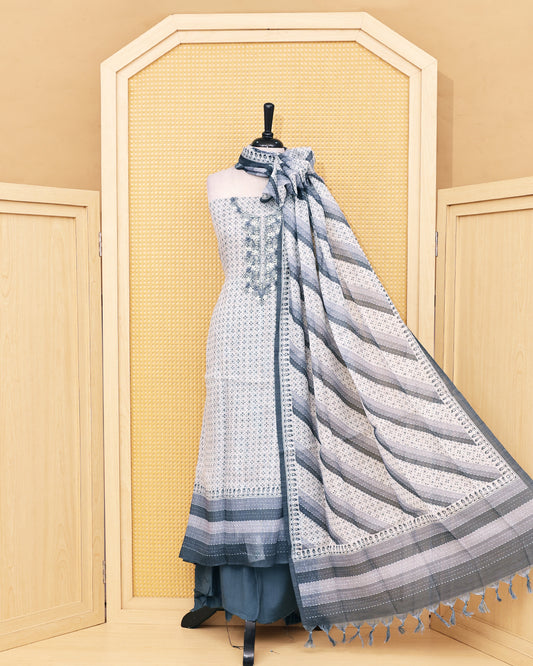 Cream colour Linen Salwar Material with  Printed body ,delicate floral embroidery on yoke, paired with a solid slate grey bottom and a beautifully striped printed dupatta with tassel detailing