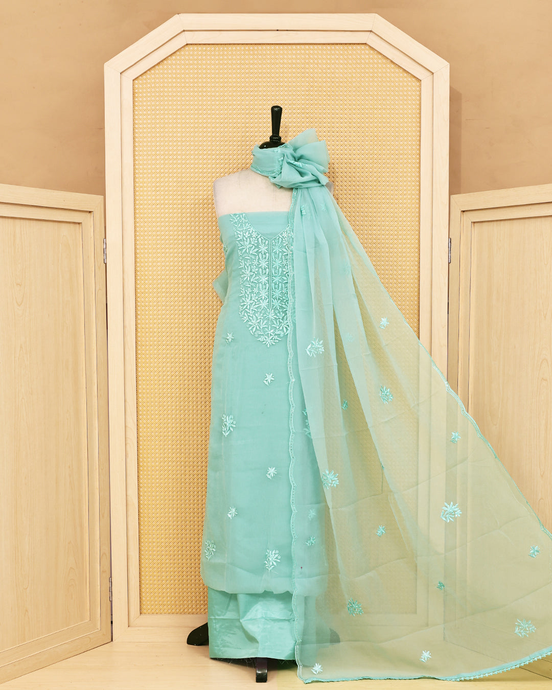 Pastel green colour Crush organza salwar material featuring thread work on body, paired with Matching bottom & dupatta.