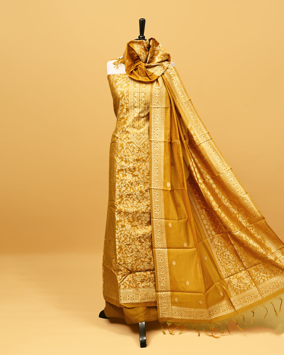 Golden colour Banaras Salwar material with gold zari floral kodi pattern work on body, matching bottom & Dupatta.