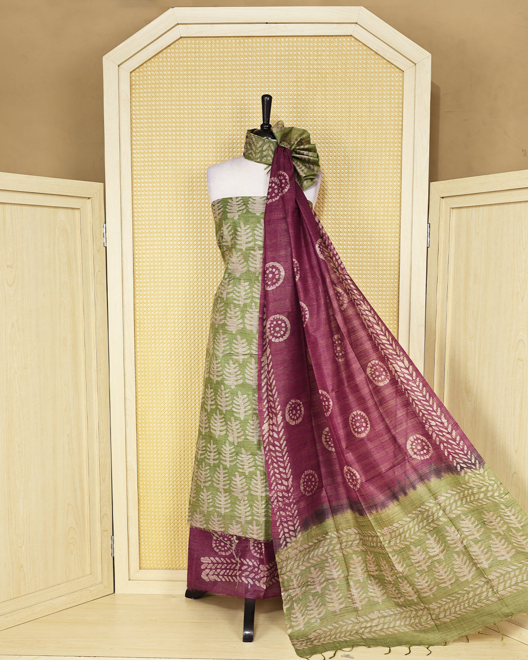 Green colour chanderi Salwar Material featuring leaf prints on the kurta, paired with a contrasting plum purple bottom and a matching printed dupatta.