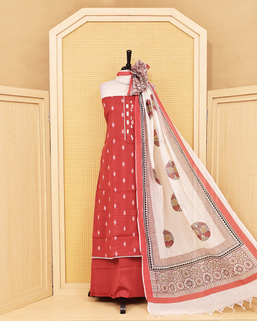Brick red colour Cotton salwar material featuring Thread with mirror work on body, paired with matching bottom & dupatta.
