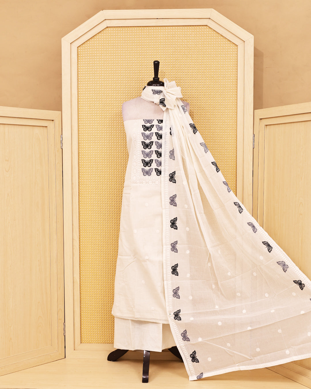 Off White colour Cotton salwar material featuring Thread Butterfly work on body, paired with matching bottom & dupatta.