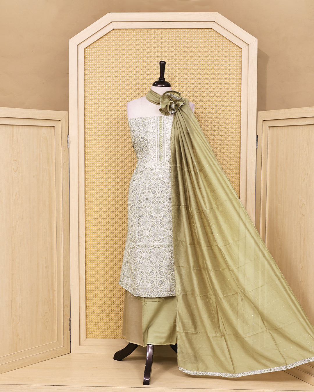 Ivory & Sage Green colour linen Salwar Material featuring intricate ethnic motifs with delicate embroidered detailing on the neckline, paired with a matching solid bottom and a graceful sage green dupatta