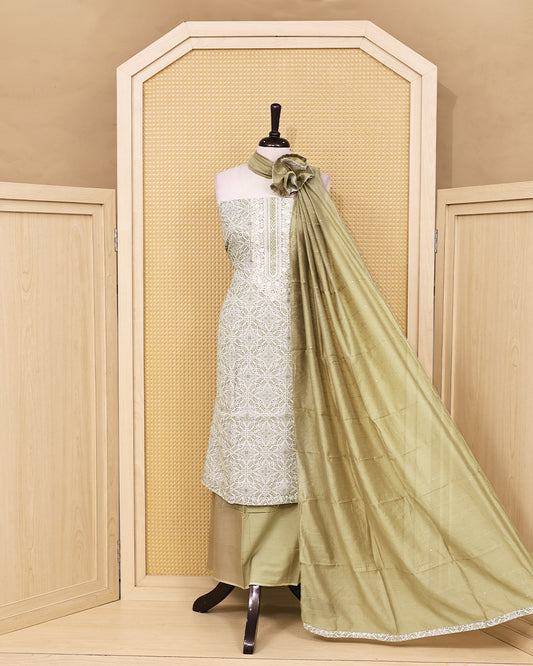 Ivory & Sage Green colour linen Salwar Material featuring intricate ethnic motifs with delicate embroidered detailing on the neckline, paired with a matching solid bottom and a graceful sage green dupatta