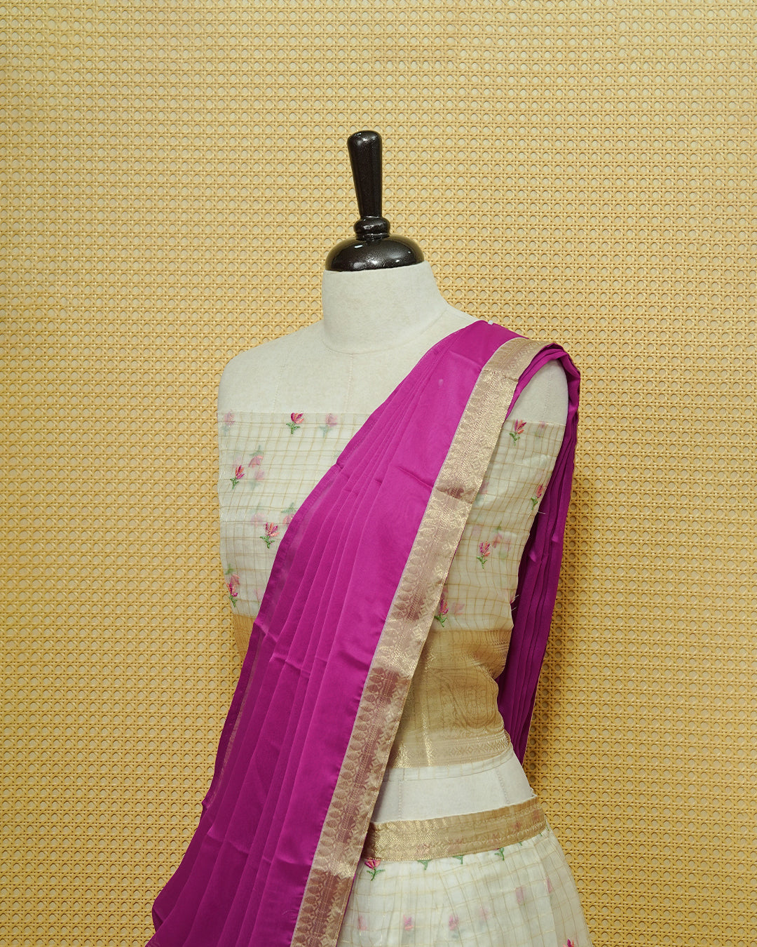 Cream colour Semi stitched Dhavani set featuring Gold zari checked pattern with floral motifs on skirt with traditional border, comes with contrast Colour Dupatta & matching blouse piece.