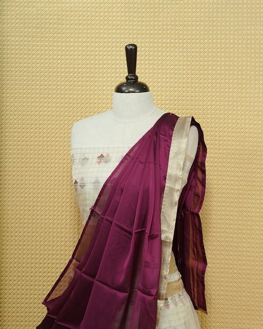 Cream colour Semi stitched Dhavani set featuring Gold zari checked pattern with floral motifs on skirt with traditional border, comes with contrast Colour Dupatta & matching blouse piece.