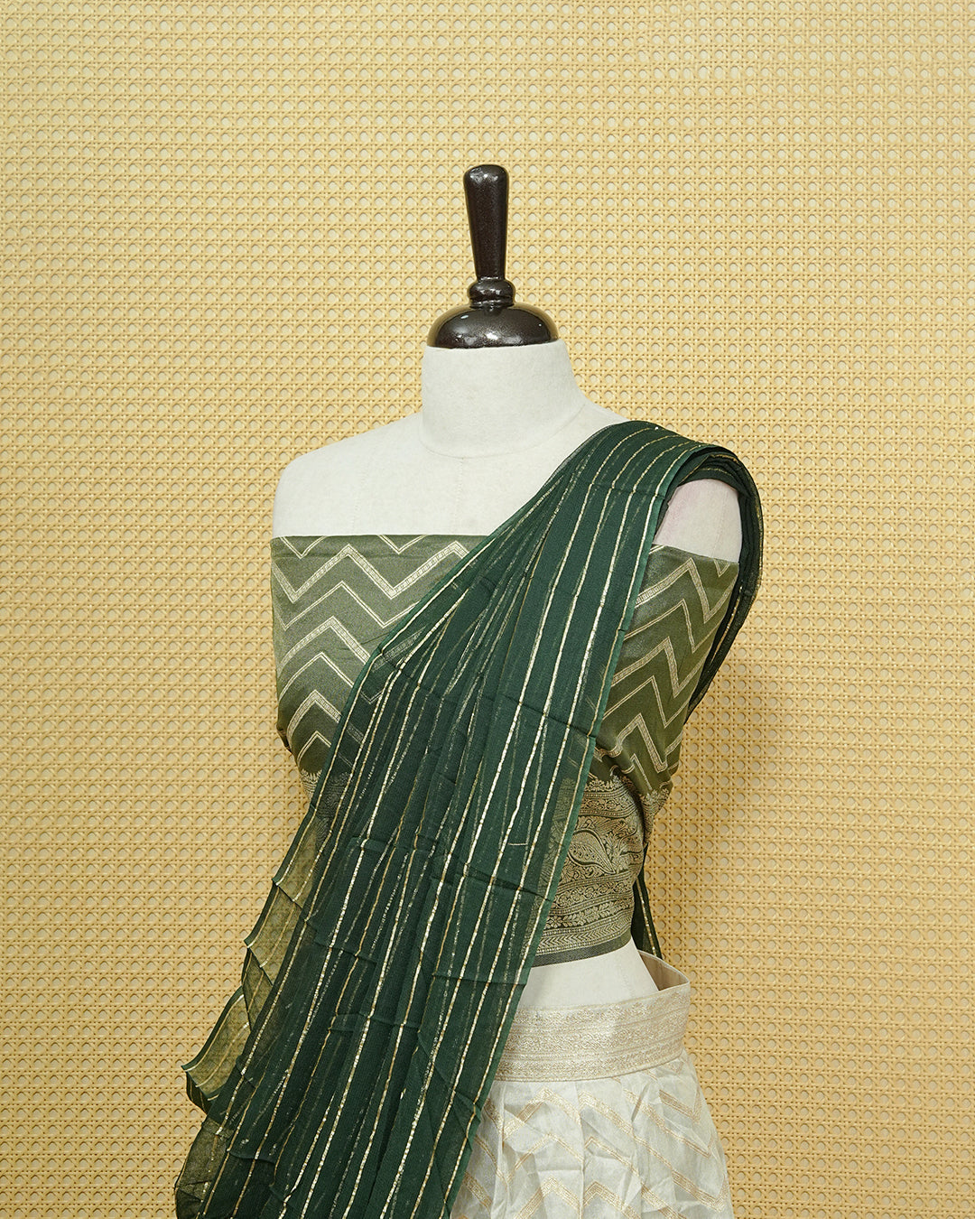 Cream colour Semi Stitched Dhavani set Featuring Gold zari Zigzag pattern With Traditional border skirt, Contrast Green colour Dupatta, Matching blouse piece.