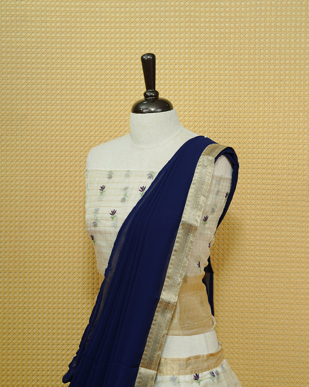 Cream colour Semi stitched Dhavani set featuring Gold zari checked pattern with floral motifs on skirt with traditional border, comes with contrast Colour Dupatta & matching blouse piece.