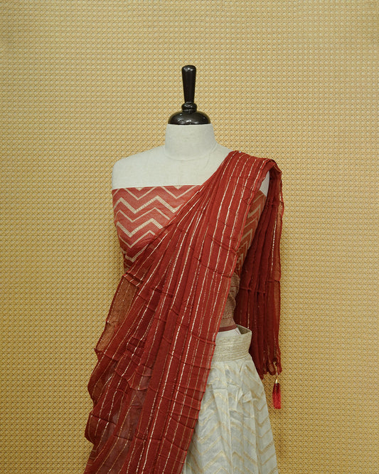 Cream colour Semi Stitched Dhavani set Featuring Gold zari Zigzag pattern With Traditional border skirt, Contrast Red colour Dupatta, Matching blouse piece.